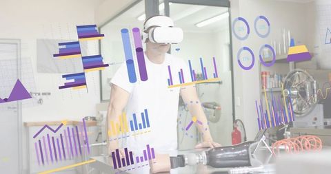 Engineer testing prosthetic limb while wearing vr headset and viewing augmented analytics