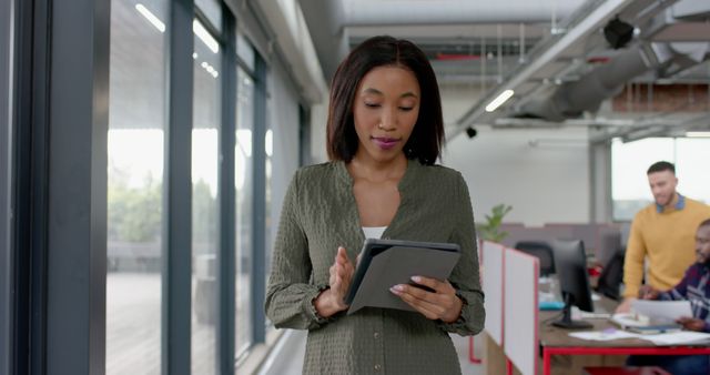 Young Professional Woman Using Tablet in Office Environment - Download Free Stock Images Pikwizard.com