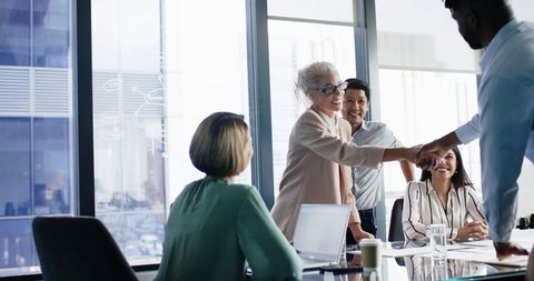 Business team collaborating and sealing partnership deal