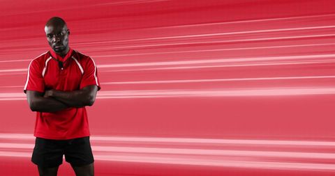 Rugby player with crossed arms on dynamic red background