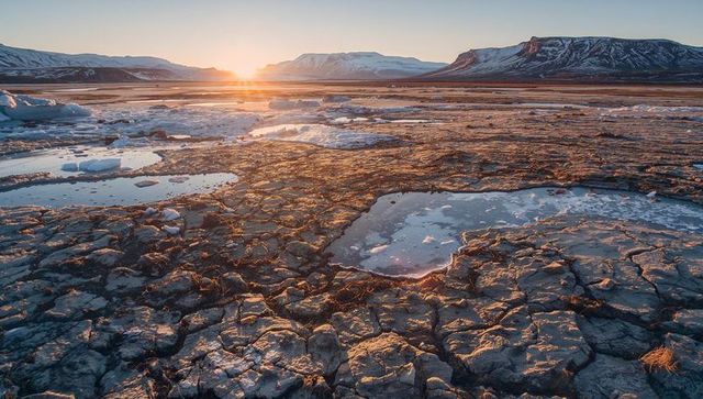 Sunset Over Rugged Glacial Plain with Ice and Water Pools