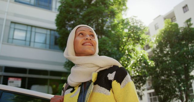 Woman in hijab enjoying sunny day in urban area - Download Free Stock Images Pikwizard.com