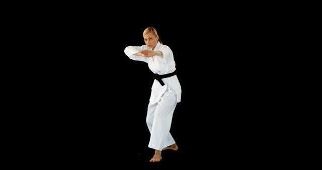 Karate Practitioner Performing Martial Arts Move in Traditional White Gi - Download Free Stock Images Pikwizard.com