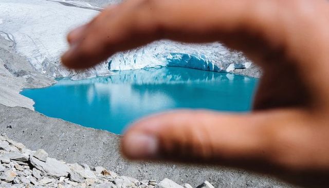 Hand Framing Turquoise Glacial Lake in Alpine Cirque with Glacier Moraine