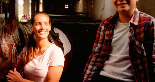 Smiling Woman with Horse and Child in Barn - Download Free Stock Images Pikwizard.com