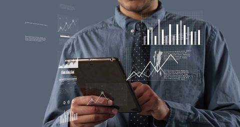 Business professional holding tablet displaying floating analytics charts and dashboard