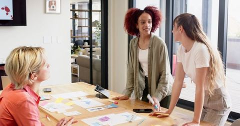 Group of Diverse Women Collaborating Around Dining Table