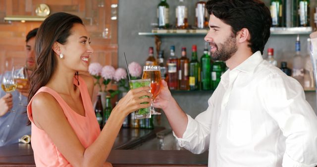 Couple toasting glasses of cocktail in restaurant 