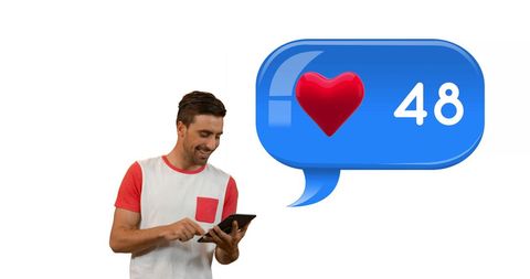 Smiling man browsing tablet with social media likes increasing