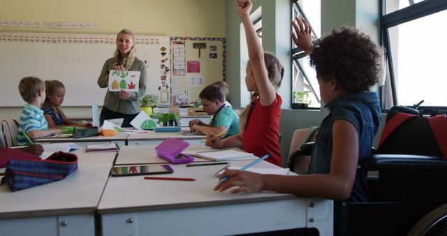 Diverse group of children attentively watching teacher in classroom - Download Free Stock Images Pikwizard.com