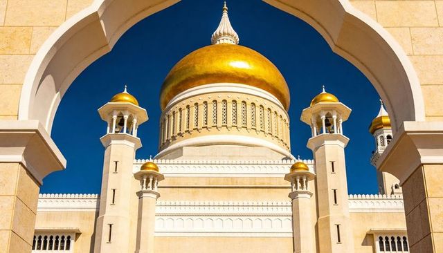 Framing golden mosque dome and minarets through ornate scalloped archway, gilded cupola