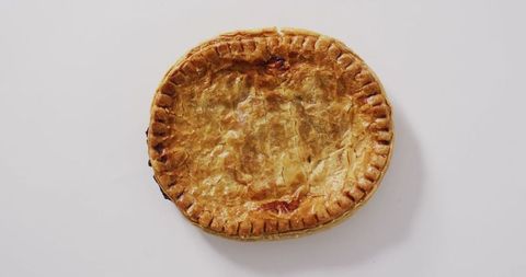 Top View of Golden Brown Pie on White Surface for Culinary Delights