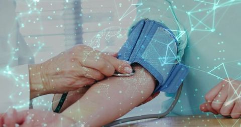 Clinician measuring blood pressure with stethoscope on patient arm digital network overlay