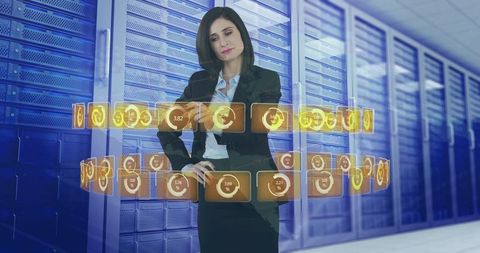 Businesswoman gesturing and manipulating holographic analytics dashboard among server racks