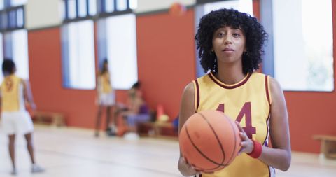 Focused African American Female Basketball Player on Indoor Court