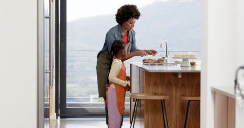 Mother and child baking together at kitchen island