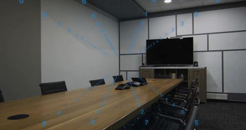 Modern conference room featuring long wooden table, dual speakerphones and large display