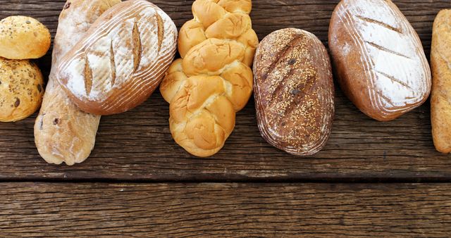 Assorted Freshly Baked Artisan Breads on Wooden Table - Download Free Stock Images Pikwizard.com