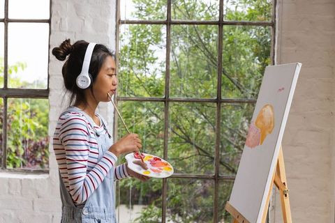 Young Woman Creating Artwork in Bright Art Studio