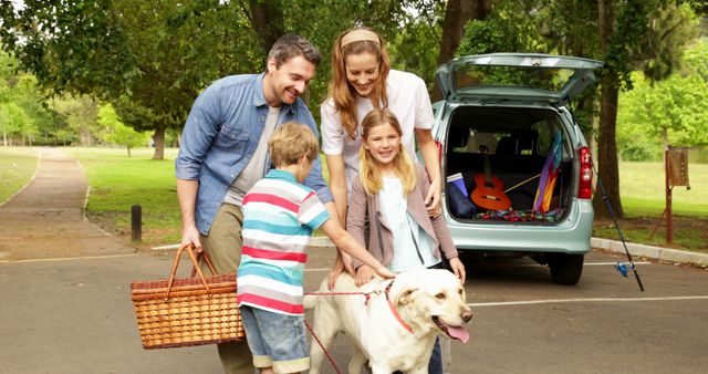 Family Enjoying Picnic Preparations with Dog at Park - Download Free Stock Images Pikwizard.com