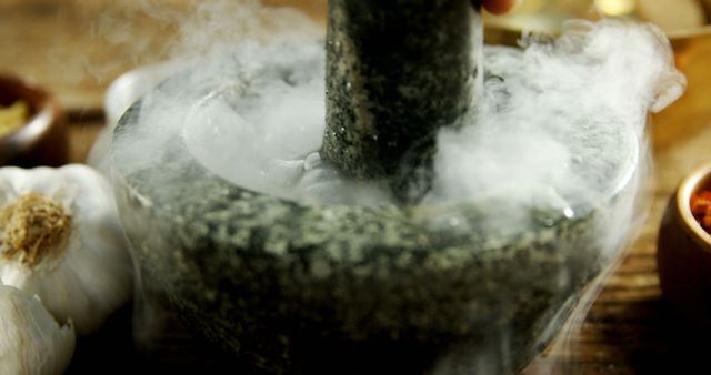 A mortar and pestle are being used to grind ingredients, emitting a cloud of aromatic smoke, with copy space. This traditional method of food preparation adds a rustic charm to the culinary process.