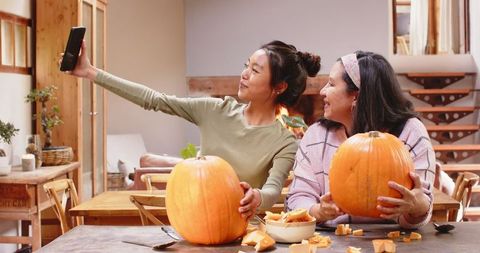 Family Bonding over Pumpkin Carving in Cozy Household