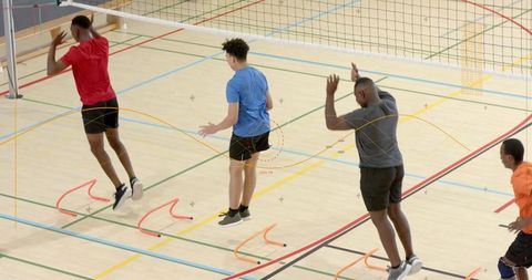 Volleyball players jumping for block during indoor agility and plyometric training session