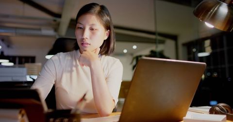 Focused Businesswoman Using Technology in Office at Night