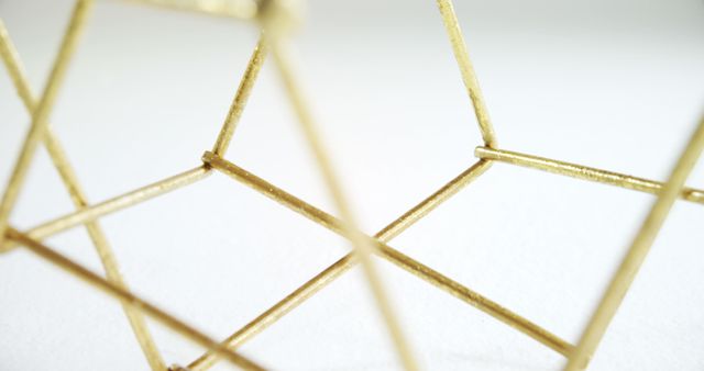 Close-up of Golden Geometric Wireframe Sculpture on White Background - Download Free Stock Images Pikwizard.com
