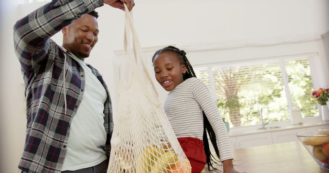 Father and Daughter Unpacking Groceries in Kitchen - Download Free Stock Images Pikwizard.com