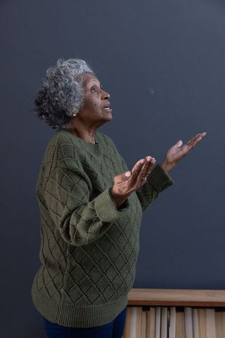 Senior woman pondering in creative studio space