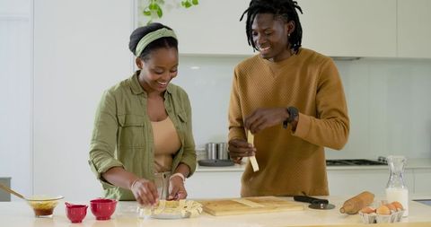 African American Couple Weaving Lattice Pie Dough on Bright Modern Kitchen Island