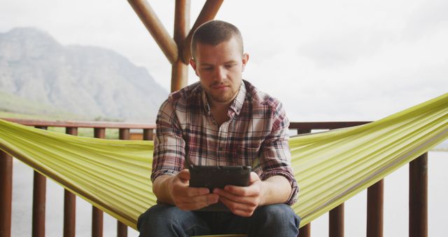 Man Relaxing in Outdoor Hammock Using Smartphone - Download Free Stock Images Pikwizard.com