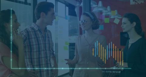 Creative team brainstorming in modern glass office