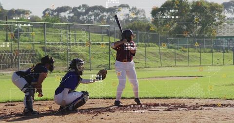 Softball Player Ready to Swing Amidst Home Plate Excitement