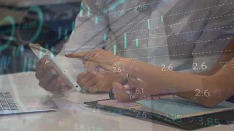 Team Analyzing Financial Graphs on Digital Tablet