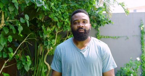 Casual portrait of man in vibrant greenery outdoors