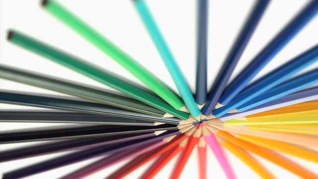 Vibrantly colored pencils converge at their tips, creating a striking starburst effect against a white background. This image symbolizes creativity and diversity and is perfect for education, art-themed layouts, or design projects emphasizing color and imagination.