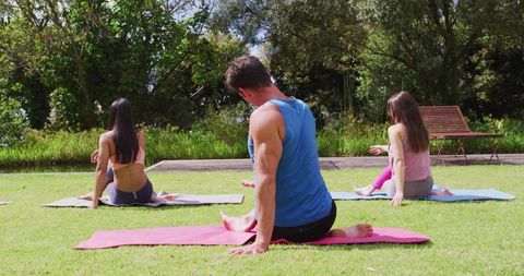 group practicing yoga outdoors in tranquil park setting - Download Free Stock Images Pikwizard.com