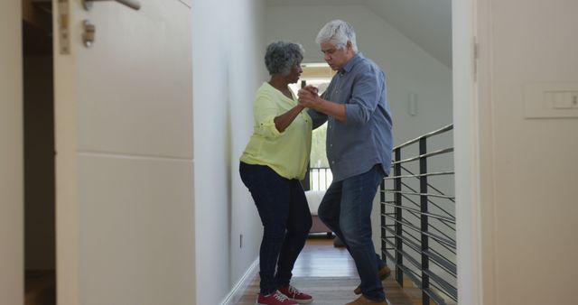 Happy senior diverse couple dancing in corridor at retirement home - Download Free Stock Photos Pikwizard.com