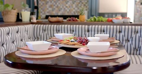 Elegant Dining Table Arrangement with Fruit and Cheese Platter