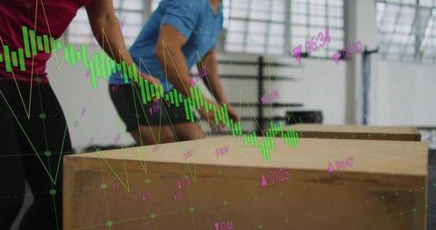 Fitness duo performing plyo box training with digital performance chart overlay and analytics