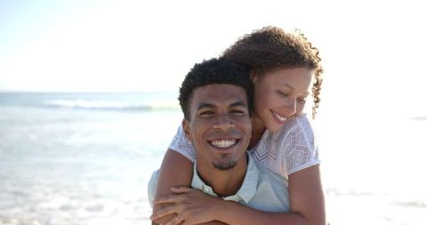 Cheerful Biracial Couple Enjoying Beach Day