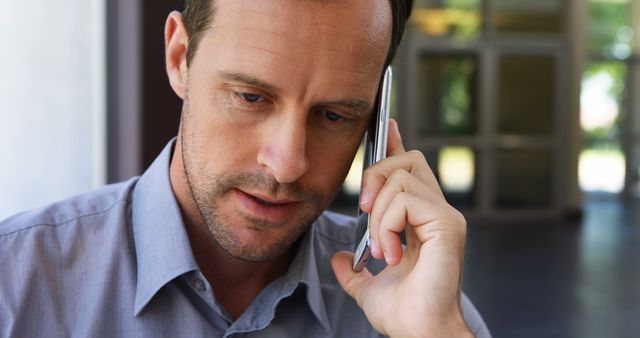 Focused Businessman Having Phone Conversation in Office - Download Free Stock Images Pikwizard.com