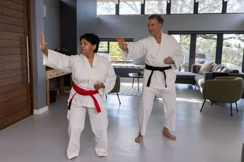Diverse Martial Artists Practicing Karate at Home