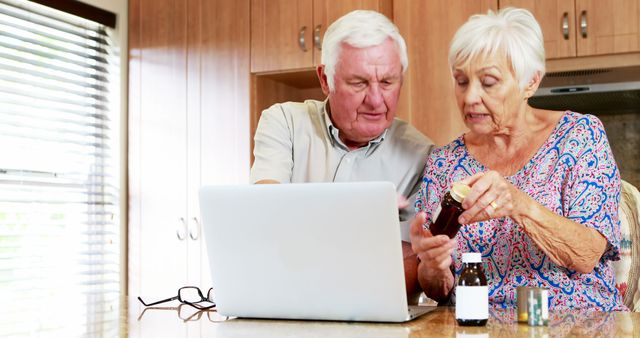 Senior Couple Researching Prescription Medication on Laptop in Kitchen - Download Free Stock Images Pikwizard.com