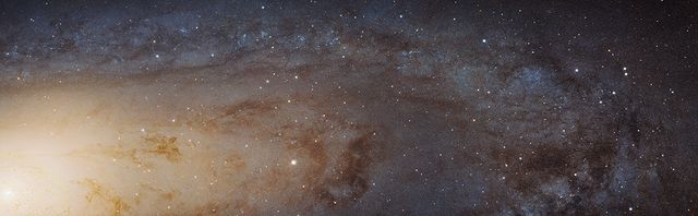 This detailed image of the Andromeda galaxy, captured by the Hubble Space Telescope, showcases over 100 million stars in a 61,000-light-year-long stretch of its disk. It is perfect for educational materials, astronomy articles, space study resources, and exhibits about cosmic structures and the universe. This image highlights the galaxy’s structure, from its dense central bulge to its sparser outer disk, and includes star-forming regions and complex dust structures.