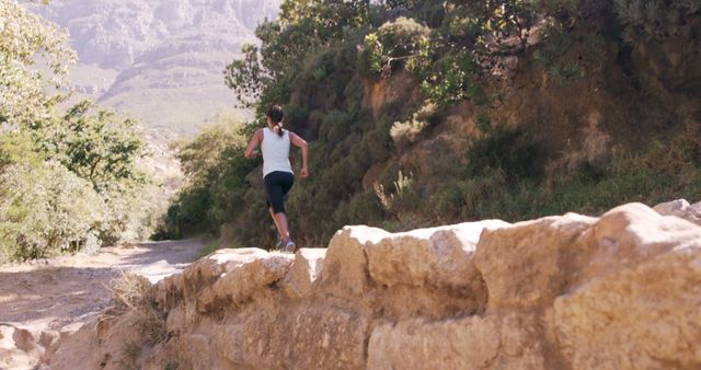 Woman Running on Mountain Trail in Sunny Weather - Download Free Stock Images Pikwizard.com