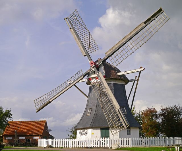 Traditional Dutch Windmill on Countryside with White Fence - Download Free Stock Photos Pikwizard.com