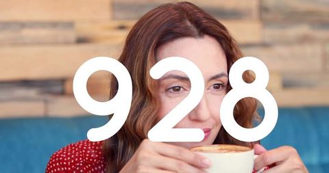 Woman Relaxing with Coffee and Digital Display in Background